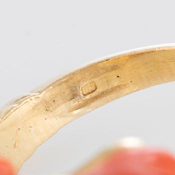 A ring in carved coral in the form of a ram's head.