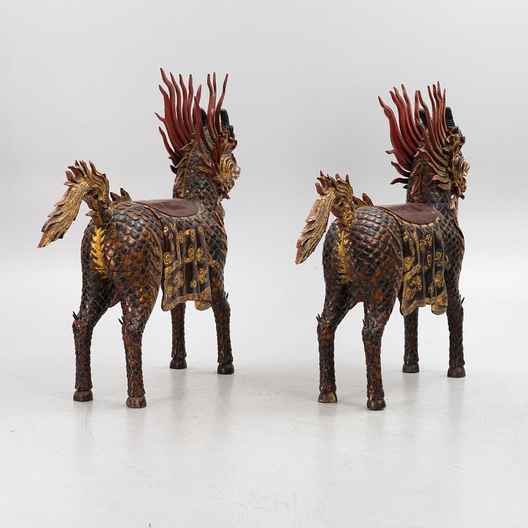 A pair of large Qilin sculptures, lacquered wood, first part of the 20th century.