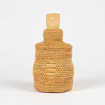 A root and glass bottle with birch stopper.