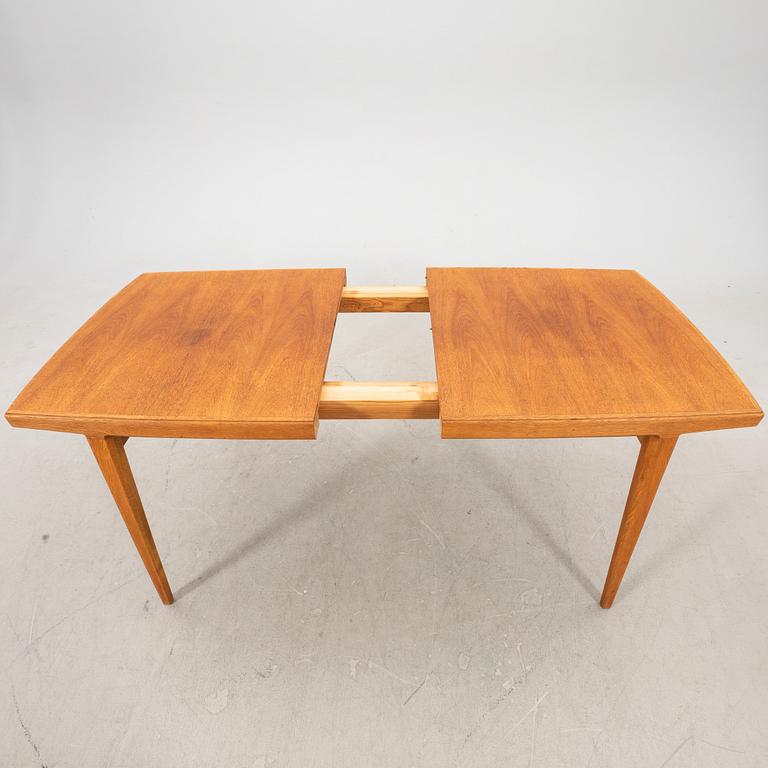 A 1950s teak dining table.