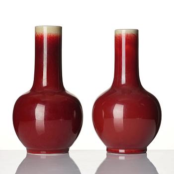 A set of two sang de boef glazed vases, late Qing dynasty, circa 1900.