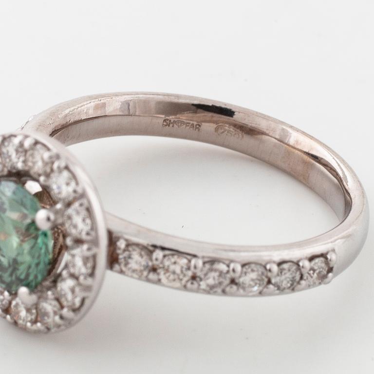 A treated green diamond and briliant cut diamonds.