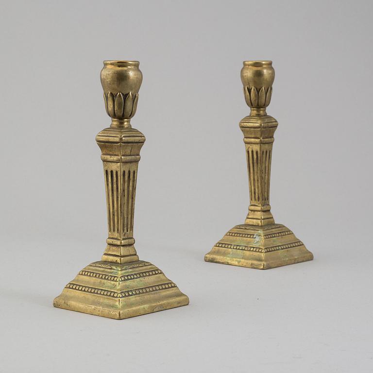 A pair of late 18th century bronze candlesticks.