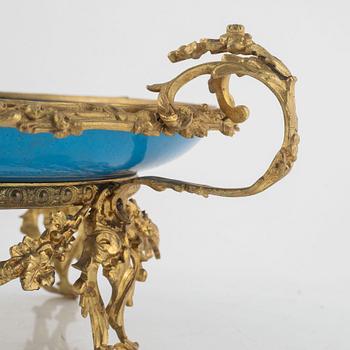 A French porcelain and brass centrepiece, second half of the 19th Century.