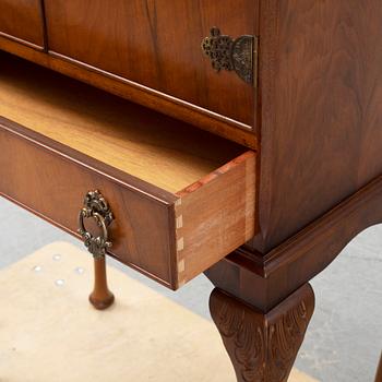 A mid 20th century walnut veneered bar cabinet.