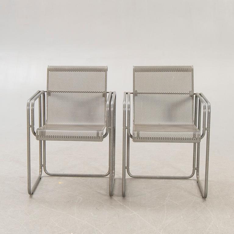 A pair of metal 1970/80s armchairs.