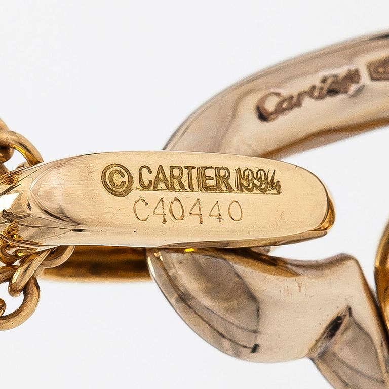 Cartier, an 18K gold necklace, with a double heart pendant.