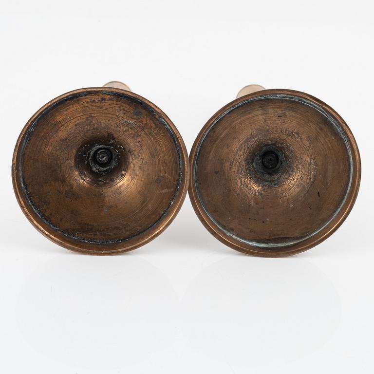 A pair of bronze candlesticks, 18th Century.