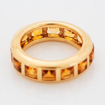 An 18K gold ring set with step-cut citrines.