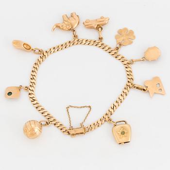 An 18K gold charm bracelet.