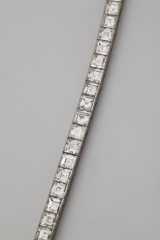 A platinum bracelet set with carré cut diamonds.