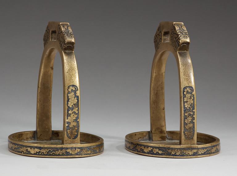 STIGBYGLAR, ett par,  patinerad och emaljerad brons. Qing dynastin, 1800-tal.