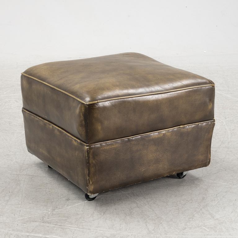 A leather upholstered easy chair with stool, second half of the 20th Century.