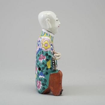 A porcelain figure of a laughing boy, Qing dynasty, 19th Century.