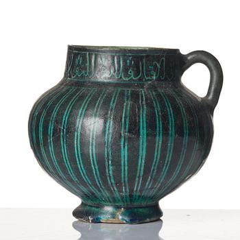 A Kashan Silhouette ware turquoise glazed pottery jug, central Iran, circa 1200.