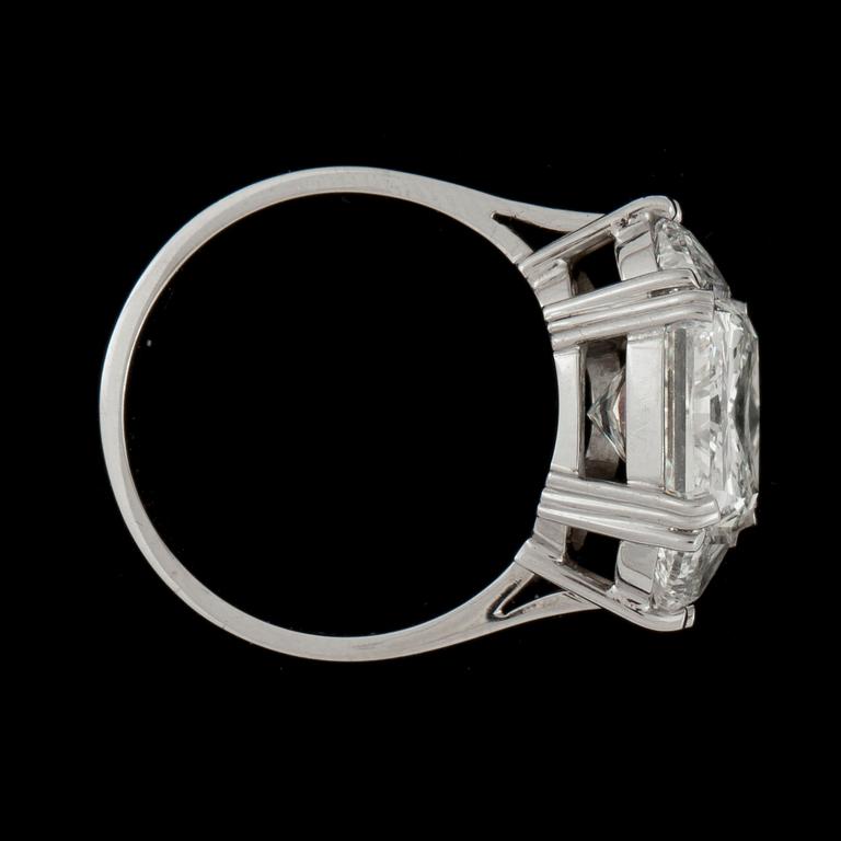A radiant cut 5.02 cts diamond ring flanked by two half-moon shaped diamonds, totally 1 ct.