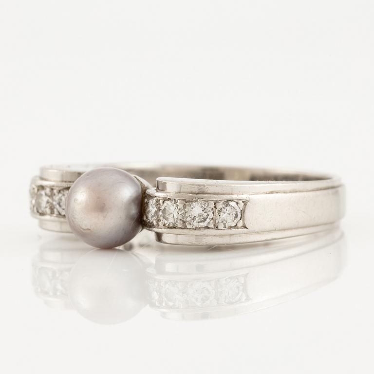 A W.A. Bolin ring in platinum with a pearl and round brilliant-cut diamonds.