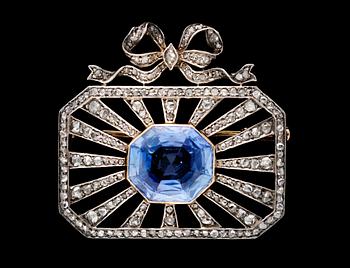 638. A platinum, diamond and blue sapphire brooch.