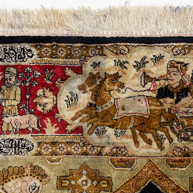 A pictorial semi-antique silk Qum rug, central Persia, c. 214 x 146 cm.