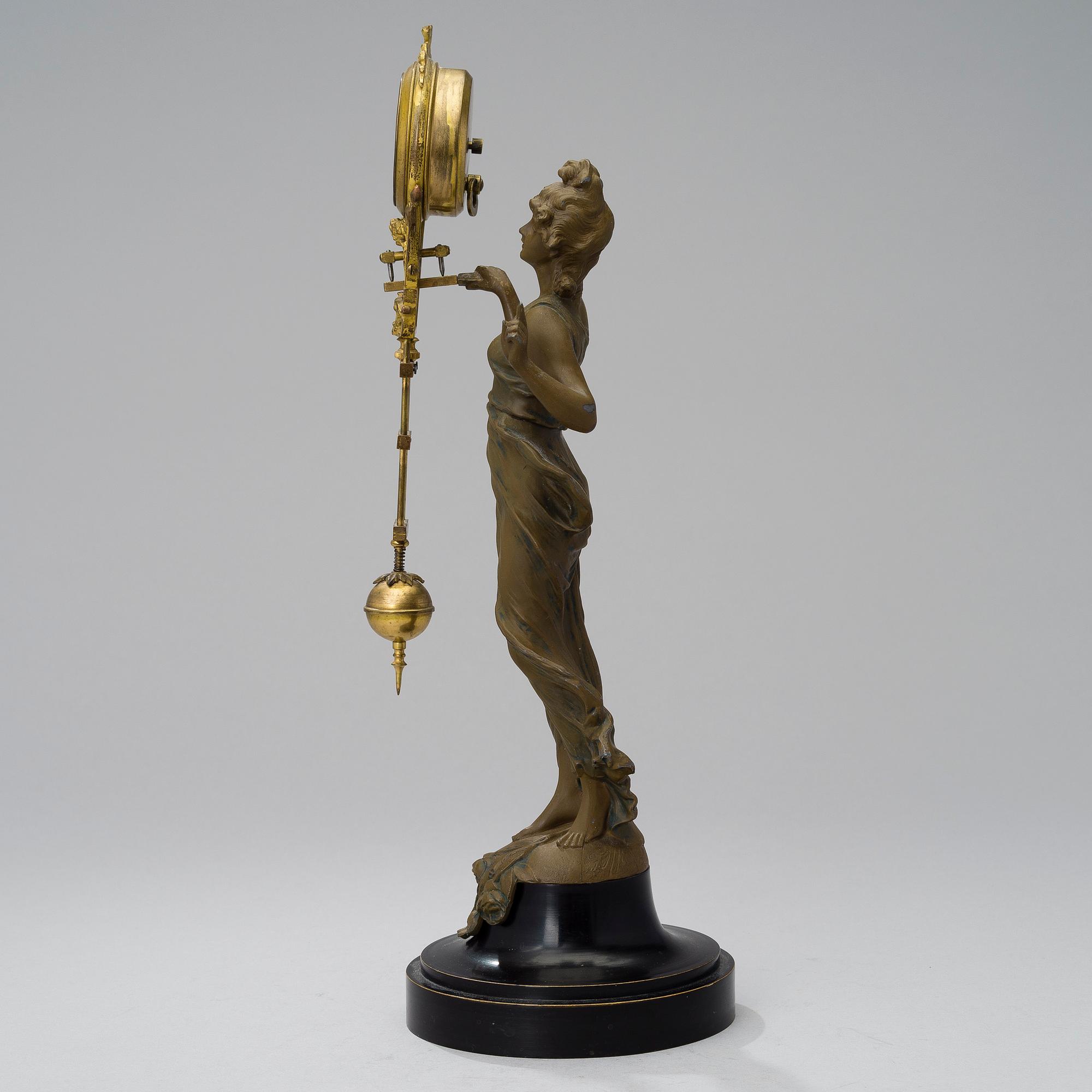A 1930s Junghans swinger clock with girl sculpture.
