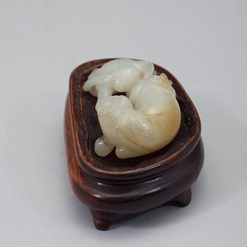 A chinese nephrite figure of a reclining horse and a monkey, early 20th Century.