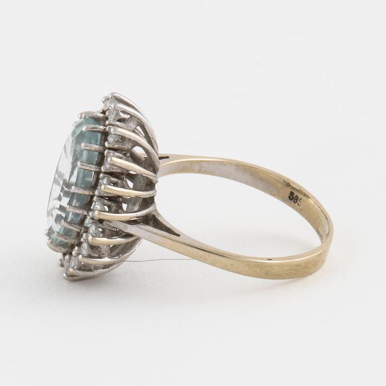 A aquamarine and brilliant cut diamond ring.