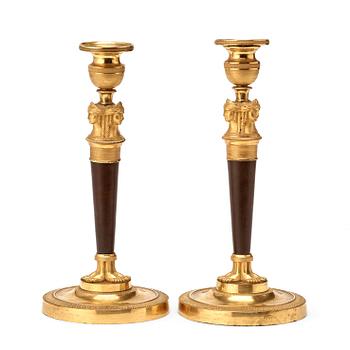 593. A pair of French Empire early 19th century candlesticks.