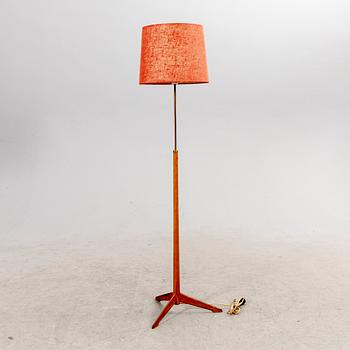 A 1960s oak and brass floor lamp.