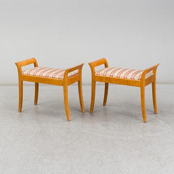 a pair of stools from the first half of the 20th century.