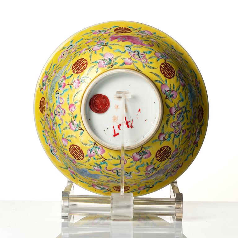 A yellow glazed 'nine bats and peaches' bowl, late Qing dynasty with Guangxu mark.