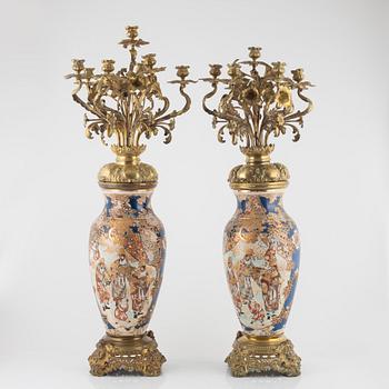 A pair of gilt-brass and satsuma ware seven-light candelabra, the porcelain Meiji period (1868-1912).