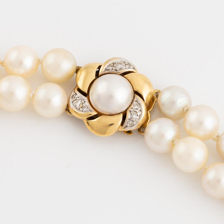 Two strand cultured pearl necklace, clasp 18K gold with half pearl and eight cut diamonds.