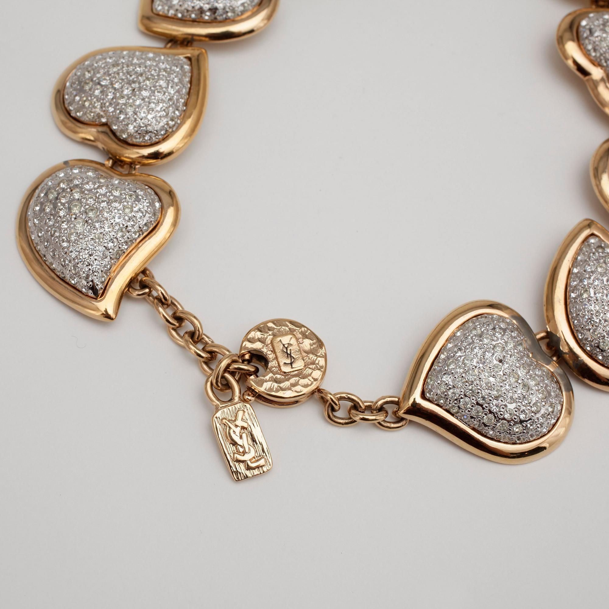 YVES SAINT LAURENT, a gold colored necklace and a pair of earclips.