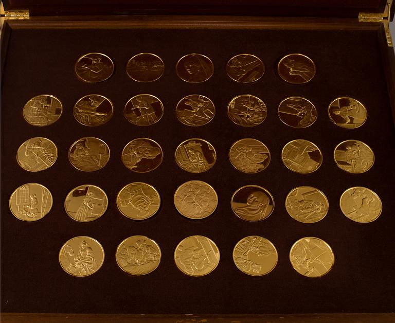 A collection of 31 gold-plated silver coins from Franklin Mint.