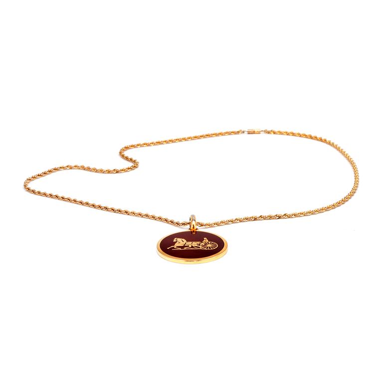 CELINE, a gold colored chain with pendant.