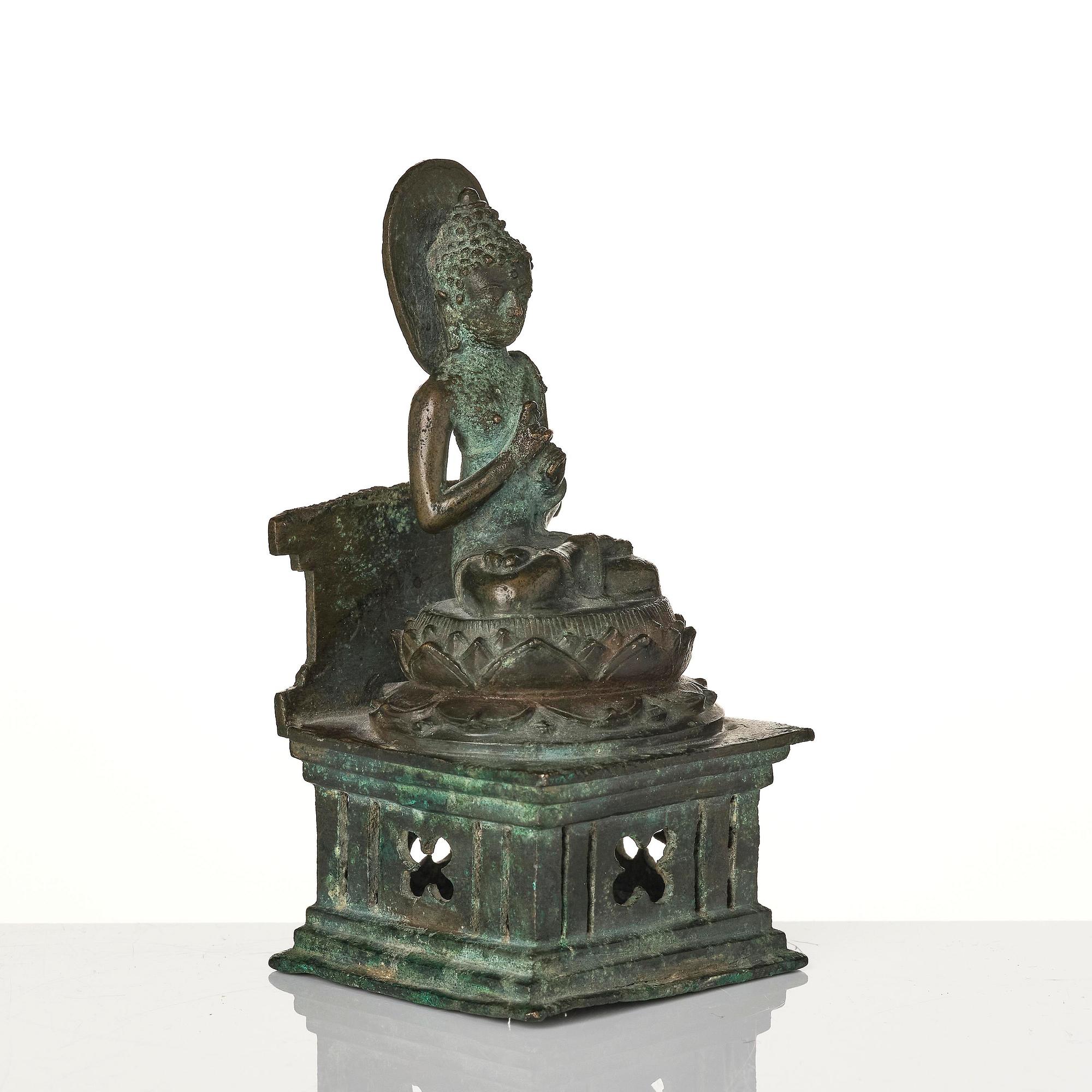 A bronze Buddha Vairocana, Eastern Java, 10th century.