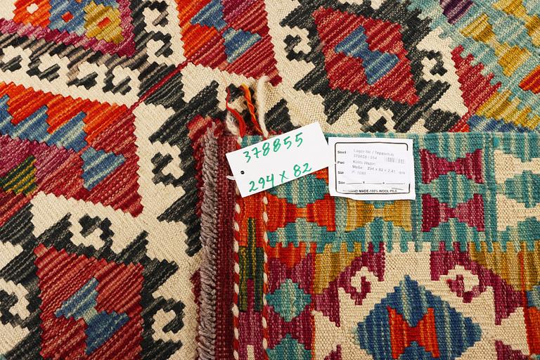 An Afghan kilim runner, c. 294 x 82 cm.