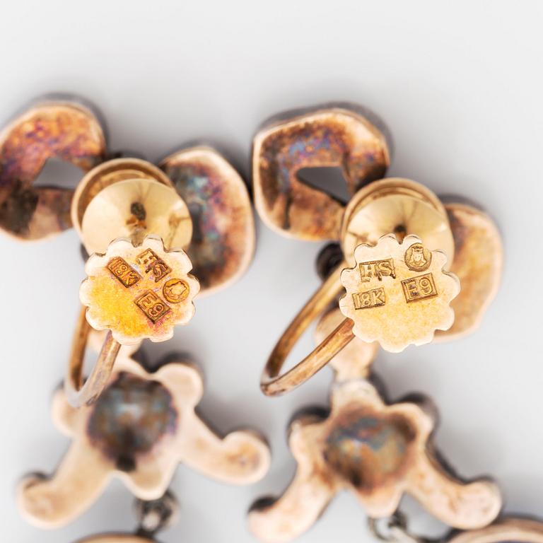 A pair of gold and silver earrings set with cabochon-cut sapphires and rose-cut diamonds.