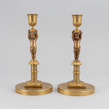 A pair of 19th Century bronze empire style candlesticks.
