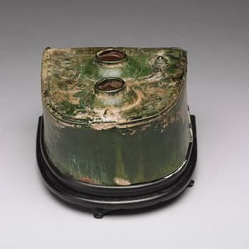 A green glazed pottery model of a stove, Han dynasty (206 BC-220 AD).