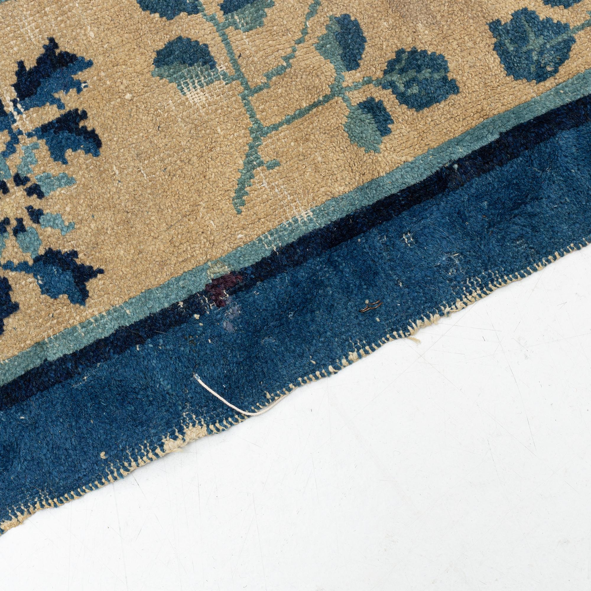 An antique Chinese carpet, c. 355 x 270 cm.