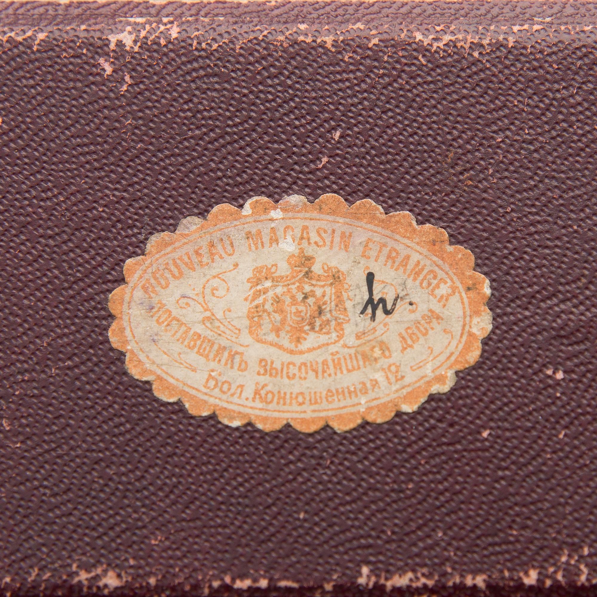 A silver case, Nikolai Kemper, and a pen and a paper knife in silver and enamel, import marks St Petersburg early 1900s.