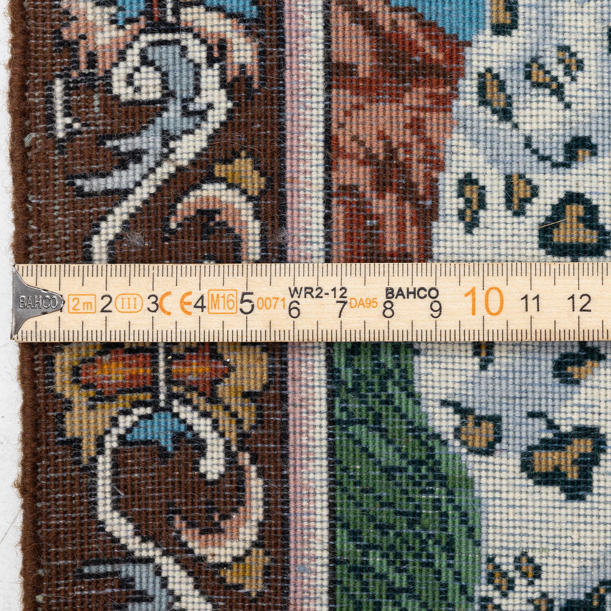 An oriental, figural rug, c. 64 x 50 cm.