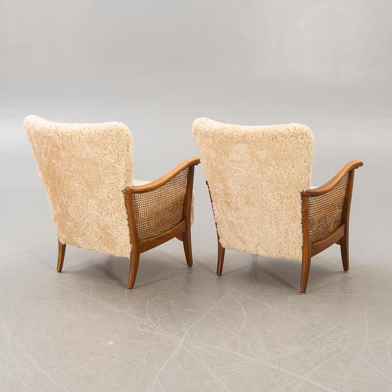 A pair of 1940/50s cheep skin armchairs.