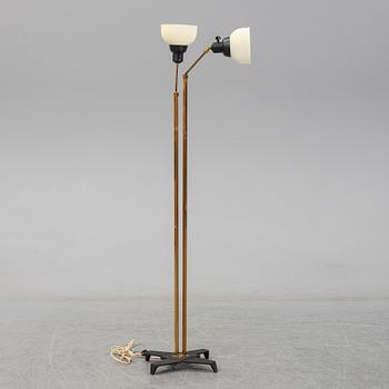 A 1950s brass and glass floor lamp.