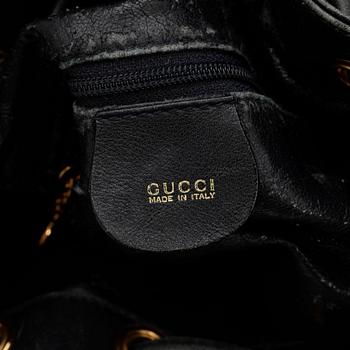 GUCCI, a dark blue leather purse.