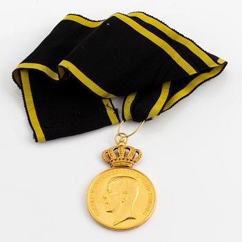 A Swedish Pro Patria gold medal for merit, with ribbon.