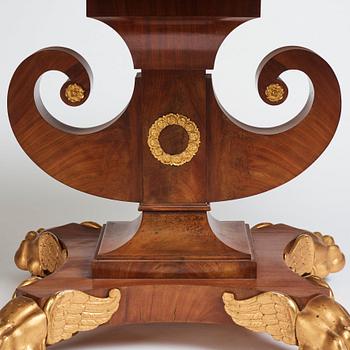 A Swedish Empire mahogany center table by Johan Öman, (Stockhom 1815-1833).