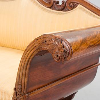 A mid 1800s mahogany sofa.