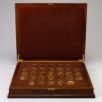 A collection of 31 gold-plated silver coins from Franklin Mint.